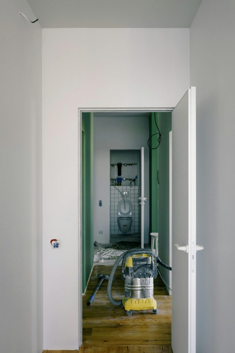 Vacuum in the middle of doorway cleaning dust