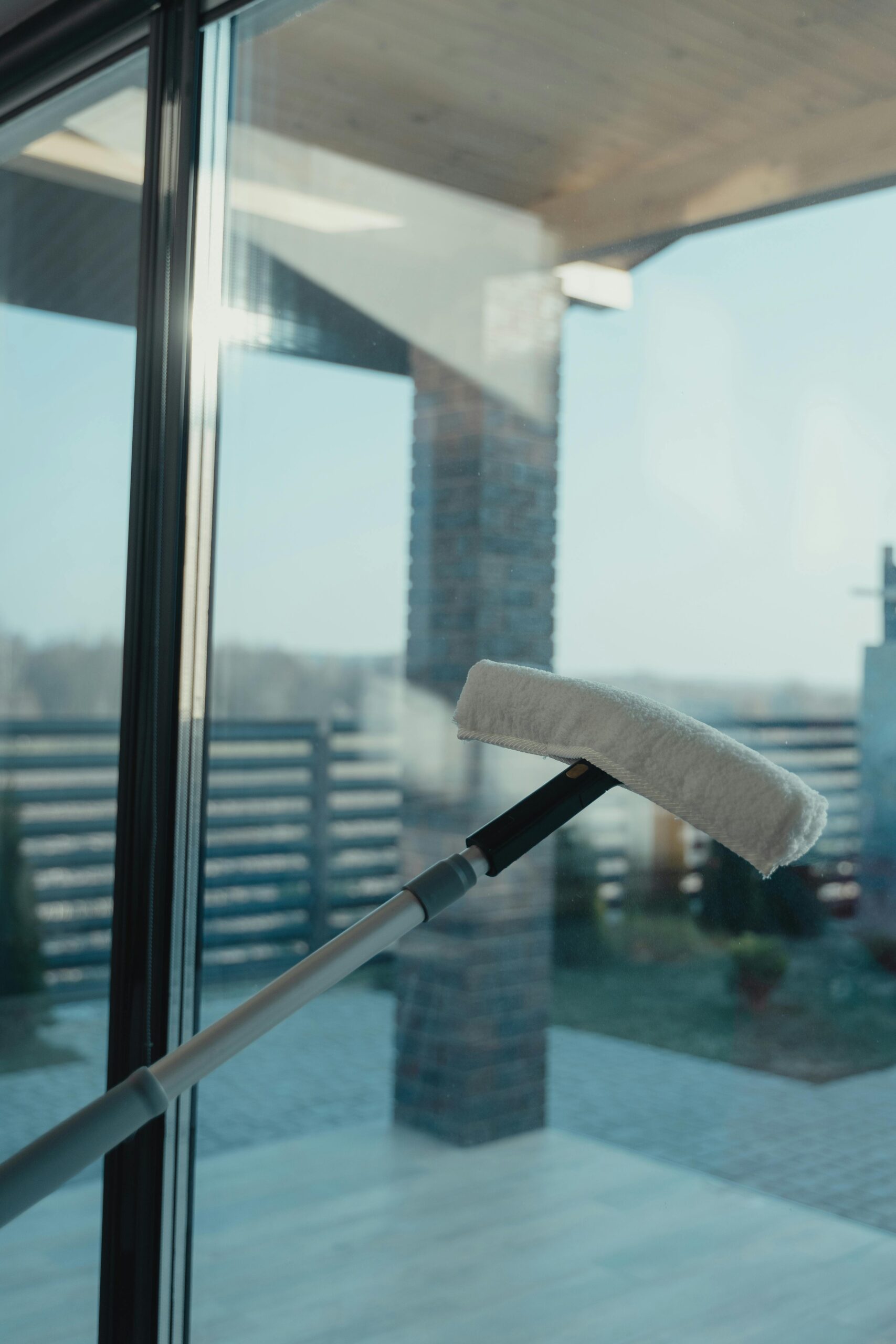 The Cleaners cleaning a window from the inside